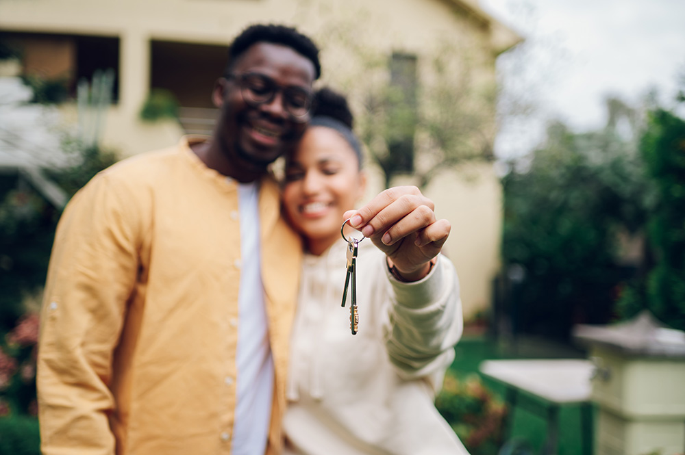 Couple holding keys to their new home